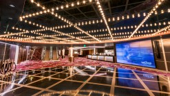 The black and gold National Harbor Theater lobby and its red carpet with geometric patterns.