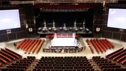 Seating is arranged around a boxing ring on the flat floor of The Venue.